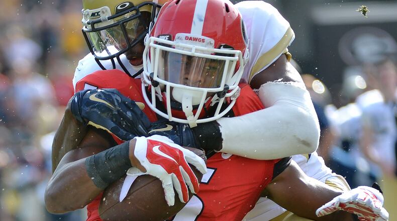November 28, 2015 Atlanta - Georgia Bulldogs wide receiver Terry Godwin (5) gets tackled from behind by Georgia Tech Yellow Jackets defensive back D.J. White (28) in the second half at Bobby Dodd Stadium on Saturday, November 28, 2015. Georgia Bulldogs won 13 - 7 over the Georgia Tech Yellow Jackets. HYOSUB SHIN / HSHIN@AJC.COM