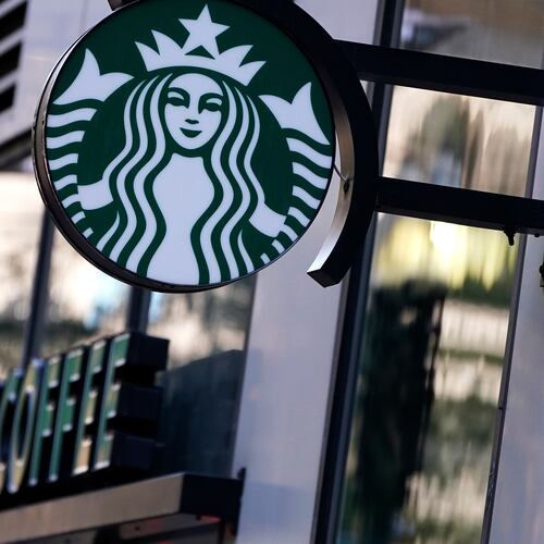 FILE - The "Siren" logo hangs outside a Starbucks Coffee shop, Wednesday, July 14, 2021, in Boston. (AP Photo/Charles Krupa, File)