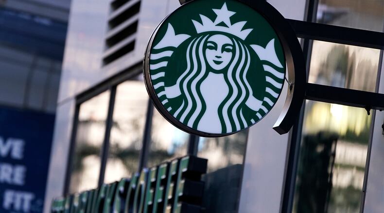 FILE - The "Siren" logo hangs outside a Starbucks Coffee shop, Wednesday, July 14, 2021, in Boston. (AP Photo/Charles Krupa, File)