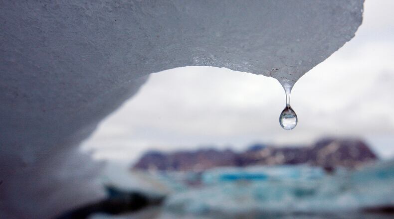 ** FILE ** In this Tuesday July 17, 2007 file photo, an iceberg melts in Kulusuk Bay, eastern Greenland. A reader-submitted question about the polar ice caps is being answered as part of an Associated Press Q&A column called "Ask AP." (AP Photo/John McConnico)