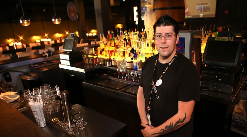 Kevin Colpo, 33, a bartender at Dave & Busters, at the Marietta location. Colpo has been working there for two years and makes $8.50 an hour plus tips. The service and hospitality sectors have seen strong growth since the recession. (HENRY TAYLOR / HENRY.TAYLOR@AJC.COM)
