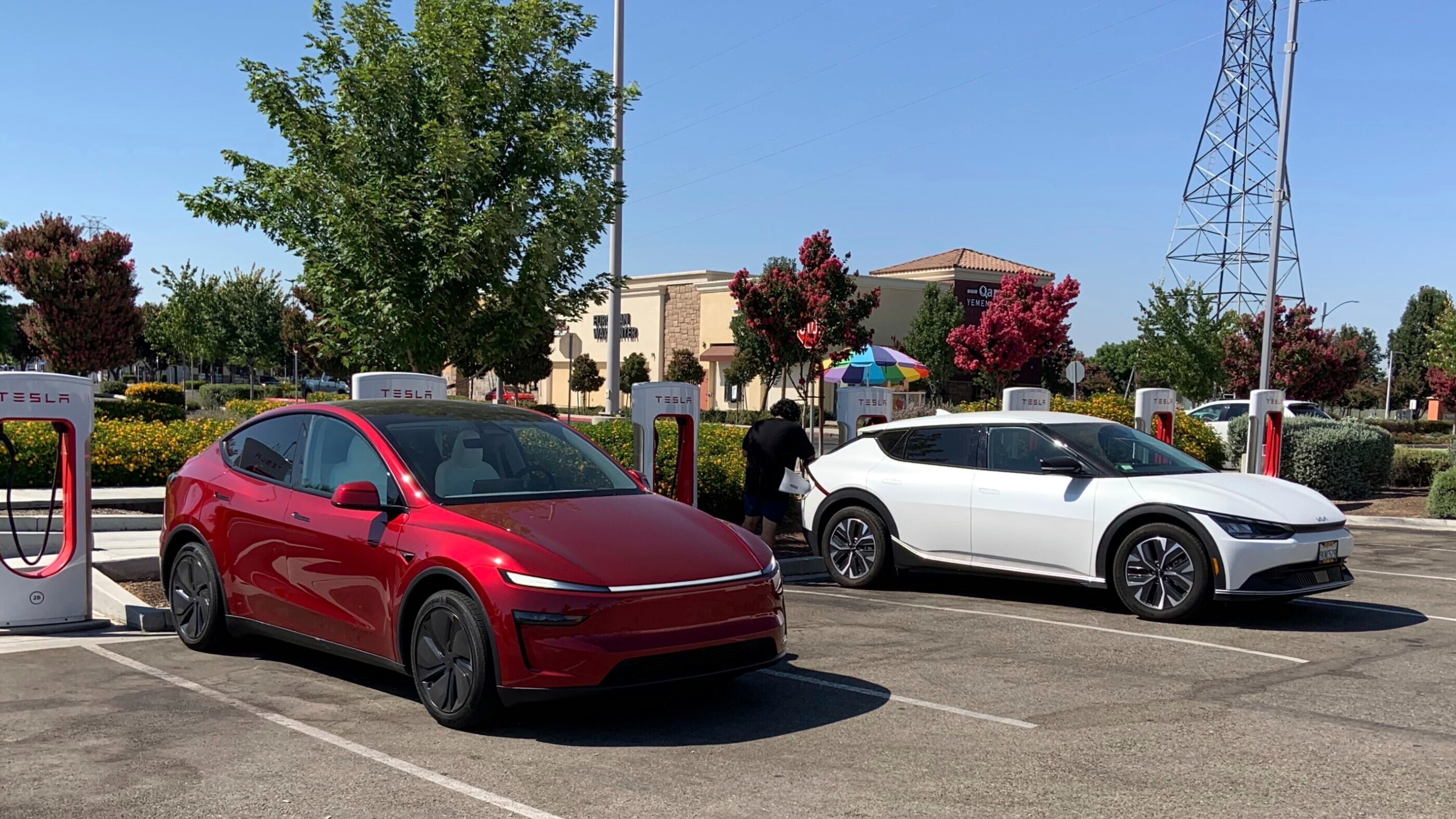 This photo provided by Edmunds shows a Tesla Model Y and a Kia EV6 parked at a Tesla Supercharger station in Fresno, Calif. Planning a cross-country trip in an EV takes extra effort, but doing it properly can make the journey almost as smooth as in a gas-powered vehicle. (Courtesy of Edmunds via AP)