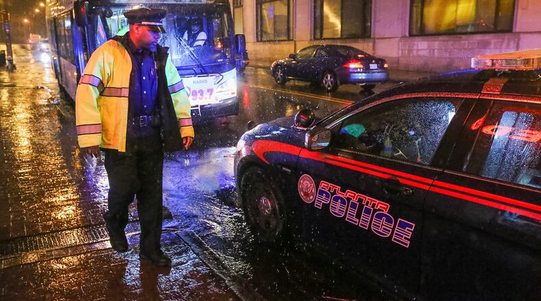Atlanta police look into an accident in which a woman was hit by a MARTA bus Friday in downtown Atlanta. JOHN SPINK/ JSPINK@AJC.COM