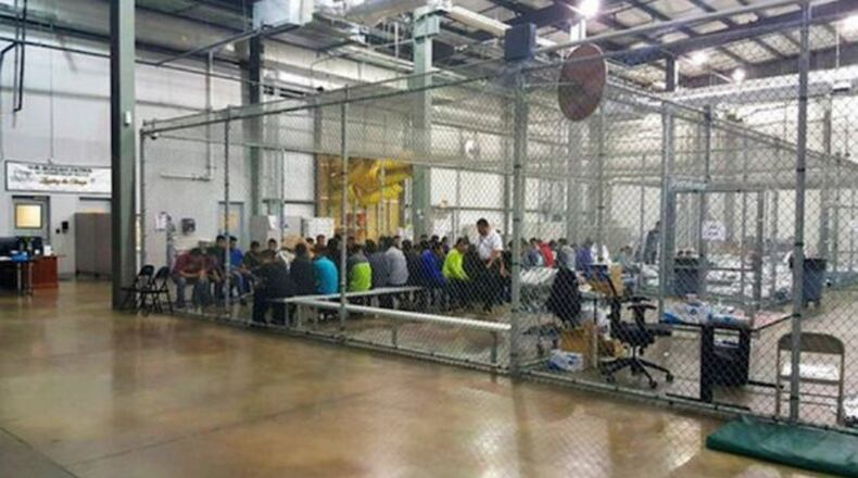 Children separated from their parents at the border are warehoused in chain-metal fencing in a former Wal-Mart facility. The lights at the facility are kept on 24 hours a day.