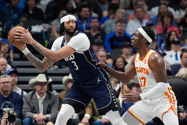 Dallas Mavericks forward Anthony Davis (3) keeps the ball from Atlanta Hawks forward Onyeka Okongwu (17) during the first half of an NBA basketball game in Dallas, Wednesday, April 2, 2025. (AP Photo/LM Otero)