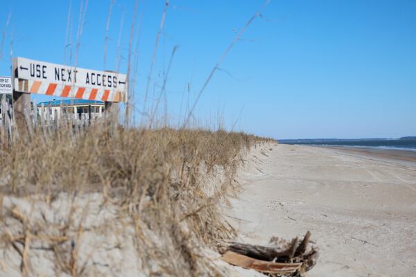 Heavy damage to the dunes on the east side of Tybee Island is causing rapid beach erosion, leading to the closure of public access points, as seen on Thursday, Jan. 14, 2026. Additionally, the Savannah River shipping channel, overseen by the U.S. Army Corps of Engineers (USACE), disrupts the natural movement of sand, accelerating the erosion process. (Miguel Martinez/AJC)