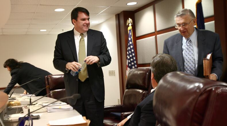 Chuck Eaton (cq), left, talks with now formr commissioners Stan Wise (cq), center, and Doug Everett (cq) after presiding over an administrative session in January. (BEN GRAY / Staff)