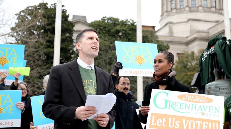 Andrew Flake, a board member for Vista Grove, speaks at a rally outside the Georgia Statehouse on Monday.