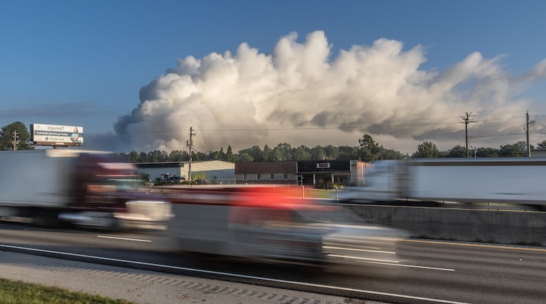 A large plume sits in the sky above Conyers on Monday following the evacuation of about 17,000 people.