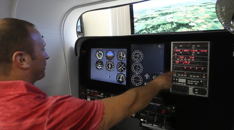 Douglas Carbone, 44, a student in the helicopter track of the aeronautical science program, during a flight simulator training session at Palm Beach State College June 09, 2015, in Lake Worth. (Bill Ingram / Palm Beach Post)