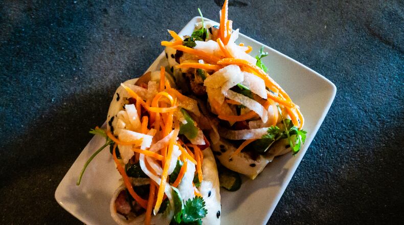 The banh mi pork belly steam buns at the Porter Beer Bar are a delicately constructed, powerfully flavored surprise.