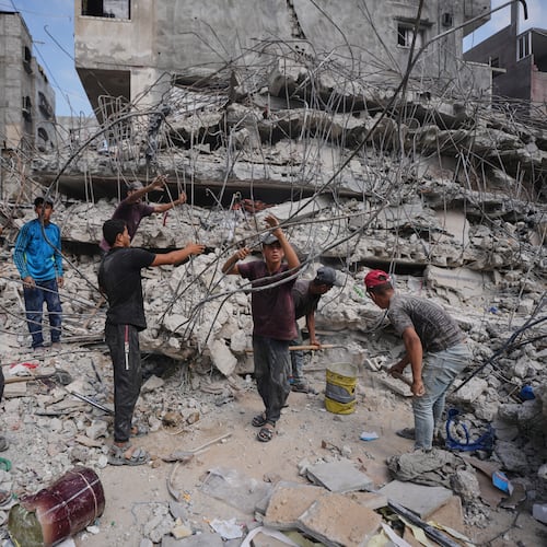 Palestinians remove iron from the rubble of buildings destroyed by Israeli airstrikes during the war with Hamas, repair and recycle it for construction, building tents or selling it, in Gaza City, Sunday, Aug. 16, 2026. (AP Photo/Jehad Alshrafi)