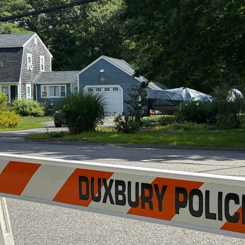 A police barricade stands outside the former home of Lindsay Clancy in Duxbury, Mass., on Friday, July 31, 2026. (AP Photo/Rodrique Ngowi)
