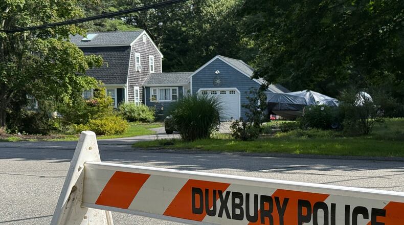 A police barricade stands outside the former home of Lindsay Clancy in Duxbury, Mass., on Friday, July 31, 2026. (AP Photo/Rodrique Ngowi)