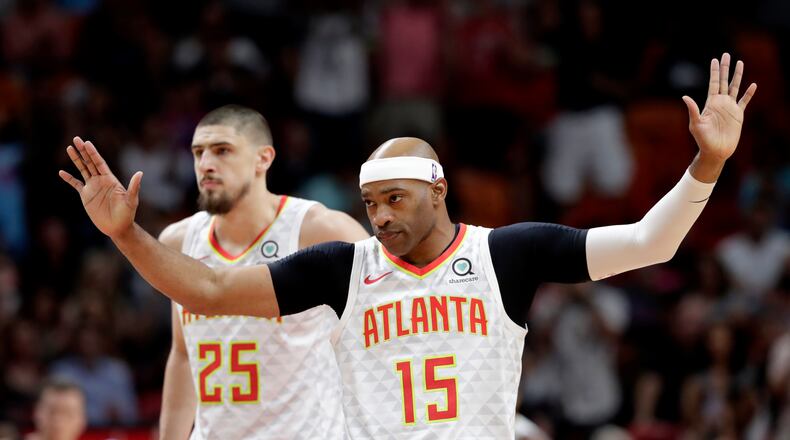 Atlanta Hawks guard Vince Carter (15) acknowledges the crowd as he is introduced during the first half of an NBA basketball game against the Miami Heat, Tuesday, Dec. 10, 2019, in Miami. (AP Photo/Lynne Sladky)