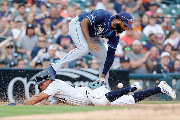 Tampa Bay Rays third baseman Junior Caminero loses the ball while tagging Detroit Tigers' Zach McKinstry sliding into third base during the fourth inning of a baseball game Wednesday, July 9, 2025, in Detroit. (AP Photo/Duane Burleson)