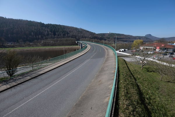 Cars parked next to the closed Elbe bridge a few days before its inauguration, in Bad Schandau, Germany, Friday March 28, 2025. (Sebastian Kahnert/dpa via AP)