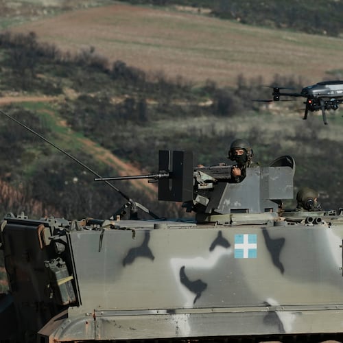 A drone flies above a Greek army armored vehicle in a live-fire exercise near the northeastern city of Alexandroupolis, Greece, testing domestically-developed drones and counter-drone systems as part of NATO's modernization efforts on Friday, Nov. 14, 2025. (AP Photo/Thanassis Stavrakis)