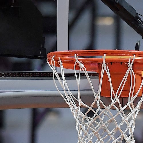 FILE - The WNBA logo is seen near a hoop before an WNBA basketball game at Mohegan Sun Arena, May 14, 2019, in Uncasville, Conn. (AP Photo/Jessica Hill, File)