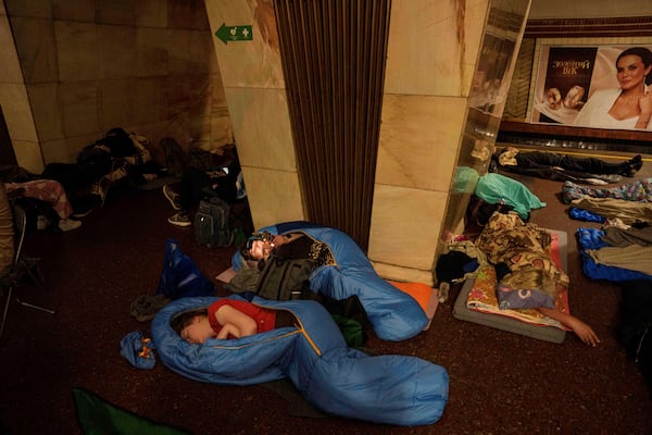 People sleep on the platform of a metro station as they take cover during a Russian attack on Kyiv, Ukraine, on Thursday, July 10, 2025. (AP Photo/Evgeniy Maloletka)