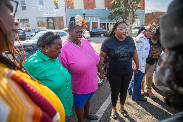 Eurie Martin's sister Helen Gilbert (second from left) prays with supporters outside the Washington County Courthouse on Thursday, Nov. 20, 2025, during a break in jury deliberations in the murder trial of three former Washington County sheriff's deputies accused of killing Martin in 2017. (Grant Blankenship/Georgia Public Broadcasting via AP)
