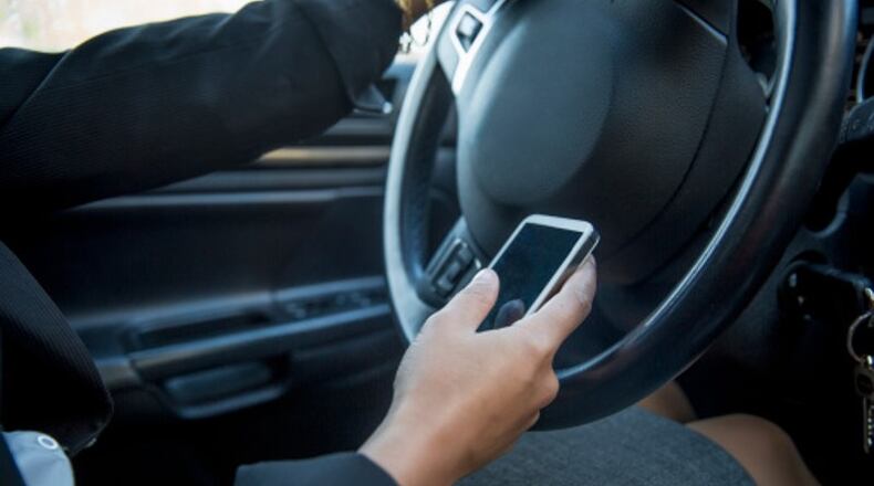 A second public hearing is scheduled for 7 p.m. Jan. 2 by the Smyrna City Council on whether to prohibit the use of handheld mobile phones and portable electronic devices while driving. AJC file photo