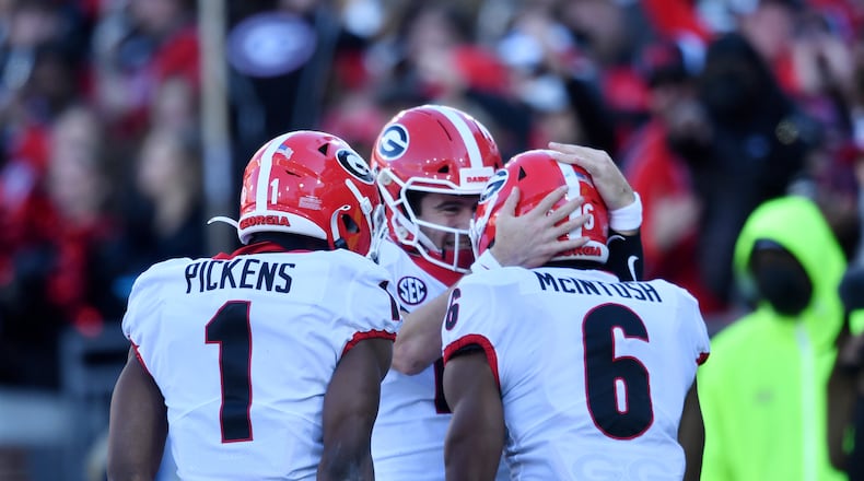 November 27, 2021 Atlanta - Georgia's running back Kenny McIntosh (6) celebrates with Georgia's quarterback Stetson Bennett (13) after scoring a touchdown during the second half of an NCAA college football game at Georgia Tech's Bobby Dodd Stadium in Atlanta on Saturday, November 27, 2021. Georgia won 45-0 over Georgia Tech. (Hyosub Shin / Hyosub.Shin@ajc.com)