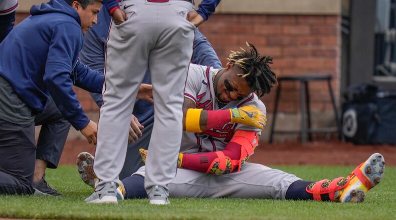 Ronald Acuna Jr. sits up after being hit by a pitch during the first inning of the second baseball game of a doubleheader against the New York Mets at Citi Field, Monday, May 1, 2023, in New York. (AP Photo/Seth Wenig)
