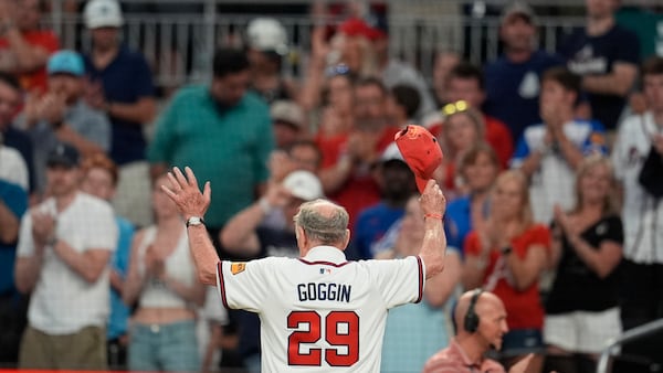 Former Braves player and Marine veteran Chuck Goggin is honored between innings of Friday's game with the Rockies.