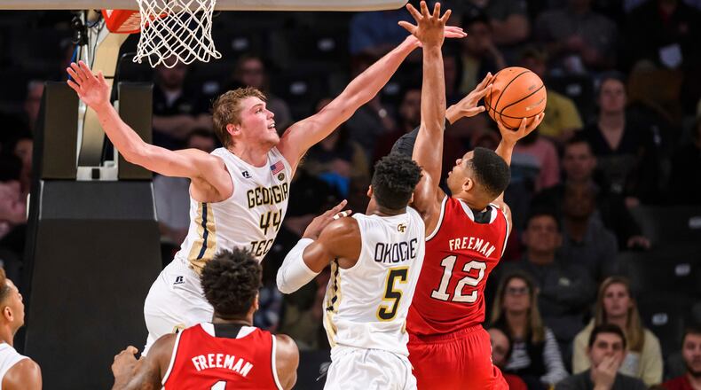 Georgia Tech center Ben Lammers (44) and guard Josh Okogie (5) defend against a shot by North Carolina State guard Allerik Freeman (12) in the first half of an NCAA college basketball game in Atlanta, Thursday, March 1, 2018. (AP Photo/Danny Karnik)