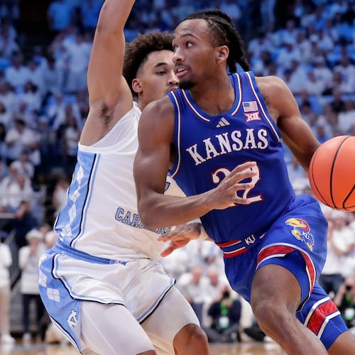 Kansas guard Darryn Peterson, right, drives against North Carolina guard Seth Trimble, left, during the second half of an NCAA college basketball game Friday, Nov. 7, 2025, in Chapel Hill, N.C. (AP Photo/Chris Seward)