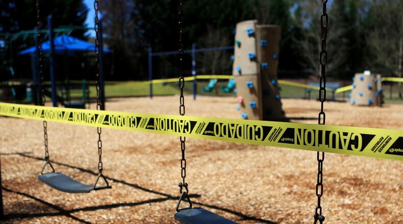 Caution tape surrounds Woodland Gate Playground on Wednesday, March 25,  2020, in Smyrna, Georgia. Some playgrounds in metro Atlanta have closed due to the outbreak of the coronavirus. (Christina Matacotta, for The Atlanta Journal-Constitution)