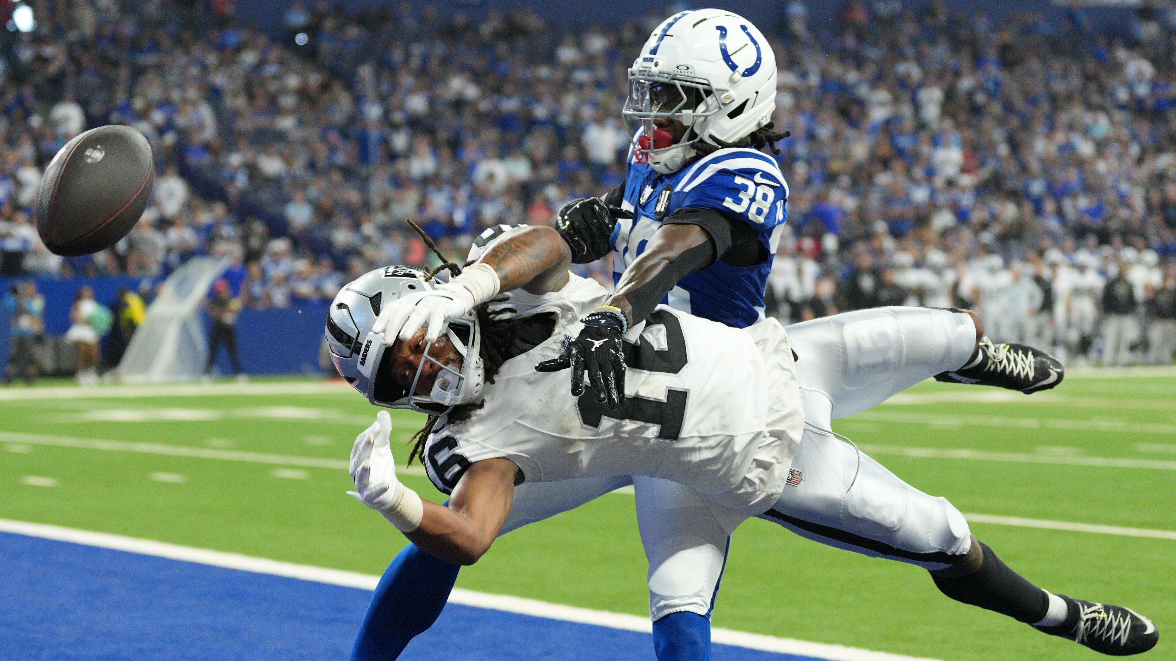 Indianapolis Colts' Chris Lammons (38) breaks up a pass intended for Las Vegas Raiders wide receiver Jakobi Meyers (16) during the second half of an NFL football game, Sunday, Oct. 5, 2025, in Indianapolis. (AP Photo/AJ Mast)