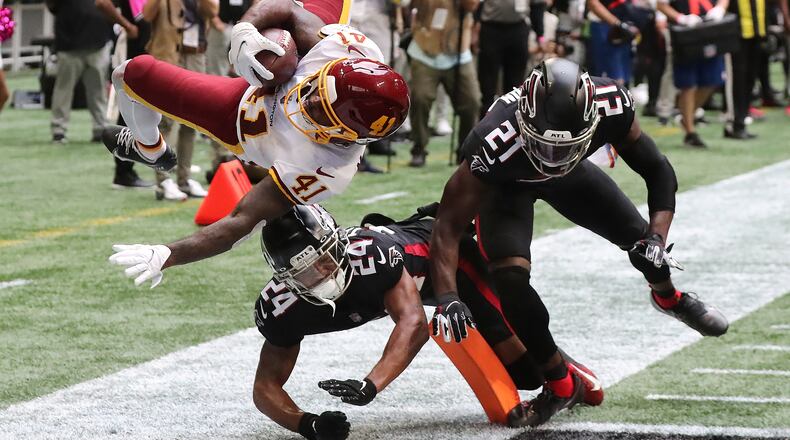 Washington Football Team running back J.D. McKissic gets into the end zone for the game-winning touchdown with Falcons cornerback A.J. Terrell (left) and safety Duron Harmon arriving late with the hit during the final minute Sunday, Oct. 3, 2021, at Mercedes-Benz Stadium in Atlanta. The Falcons lost 34-30. (Curtis Compton / Curtis.Compton@ajc.com)
