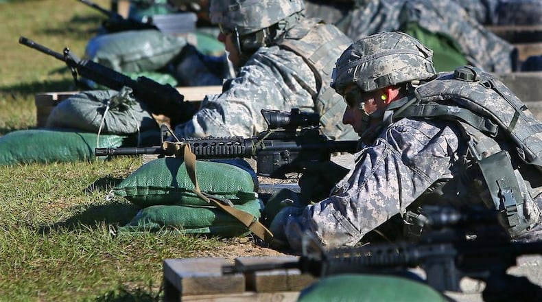 111313 FORT STEWART: Major Matt Howard (left), Dahlonega, and Captain Craig Keller (right), Marietta, zero therr weapons at the firing range while training for deployment to Afghanistan in 2013. Fort Stewart could benefit from President Donald Trump's proposed military spending increase. CURTIS COMPTON /staff CCOMPTON@AJC.COM