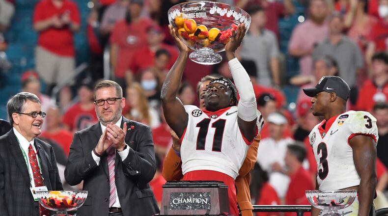December 31, 2021 Miami Gardens, Florida - Georgia defensive back Derion Kendrick (11) holds up a trophy celebrating after they won Orange Bowl over Michigan at Hard Rock Stadium in Miami Gardens, Florida on Friday, December 31, 2021. (Hyosub Shin / Hyosub.Shin@ajc.com)