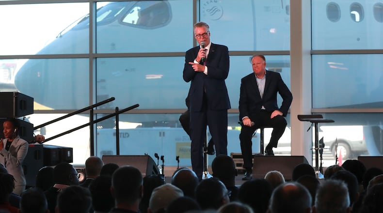 Delta CEO Ed Bastian (left) and COO Gil West unveil the new A220 aircraft while celebrating the 10-year anniversary of merging with Northwest at the Delta Air Lines TechOps on Monday, Oct 29, 2018, in Atlanta. Curtis Compton/ccompton@ajc.com
