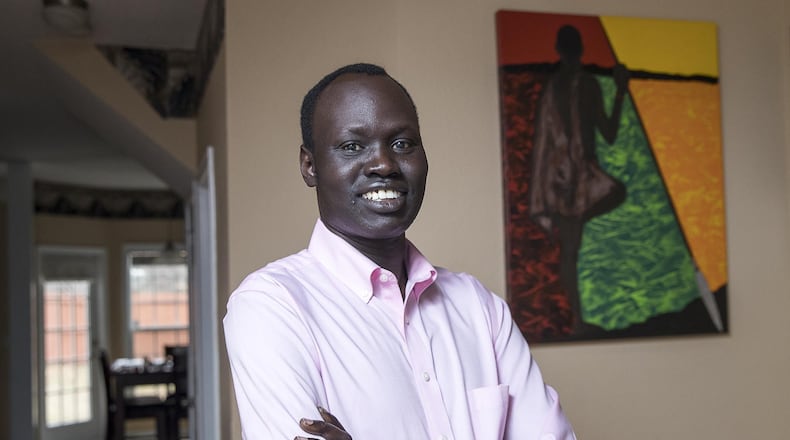 When Abraham Deng Ater left South Sudan as a child, he promised his father he would pursue an education. Ater, shown in his home in Snellville, is a public health researcher for the Centers for Disease Control and Prevention, working as a contractor from Northrop Grumman. He recently graduated from Georgia Southern University with his doctor of public health in public health leadership.