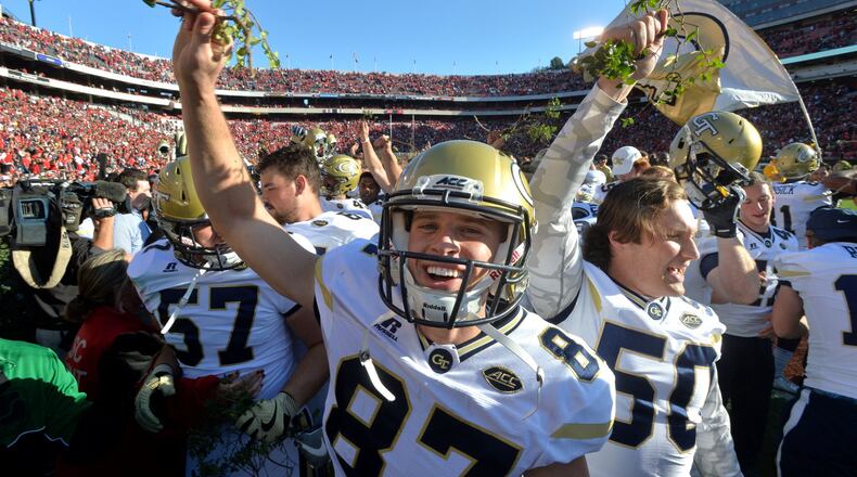 Georgia Tech kicker Harrison Butker (87) and other players celebrate their 28-27 win over Georgia with a piece of the Sanford Stadium hedges at Sanford Stadium on Saturday, November 26, 2016. HYOSUB SHIN / HSHIN@AJC.COM