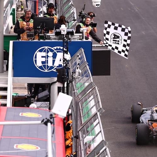 The checkered flag is waved as McLaren driver Lando Norris of Britain crosses the finish line to win the Brazilian Formula One Grand Prix at the Interlagos race track in Sao Paulo, Sunday, Nov. 9, 2025. (Jean Carniel /Pool Photo via AP)