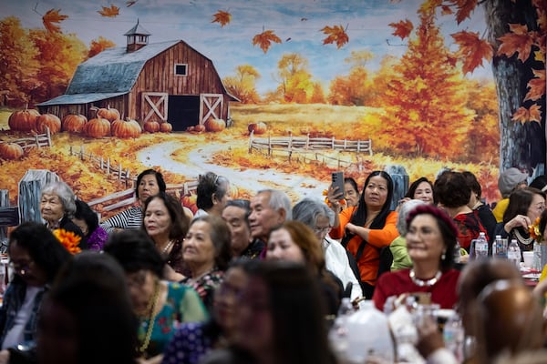 Seniors attend the Thanksgiving Celebration at the First Senior Center. (Jason Getz / AJC)