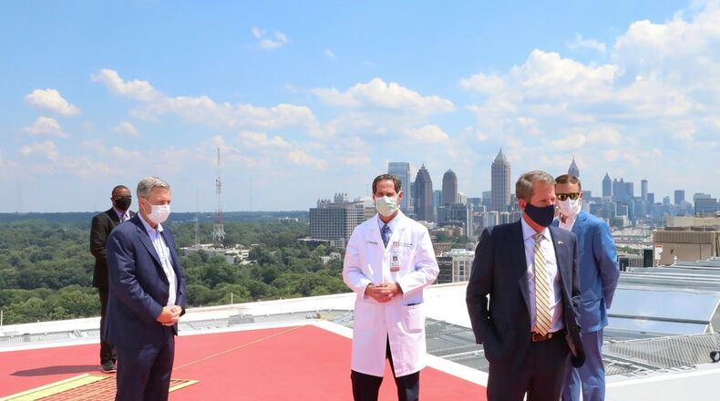 Gov. Brian Kemp and Piedmont Healthcare staffers atop the new Marcus Tower.