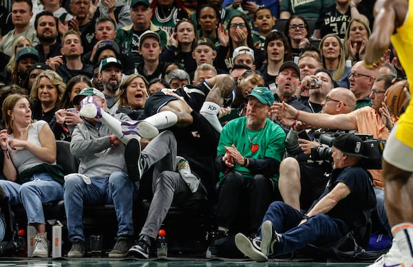 Milwaukee Bucks' Kevin Porter Jr. leaps into the crowd trying to save a ball against the Indiana Pacers during the first half of Game 4 of a first-round NBA basketball playoff series Sunday, April 27, 2025, in Milwaukee. (AP Photo/Jeffrey Phelps)