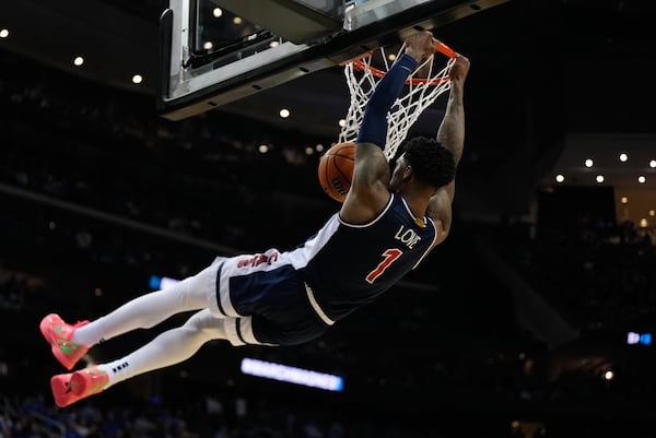 Arizona guard Caleb Love (1) dunks against Duke during the second half of a Sweet 16 round NCAA college basketball tournament game, Friday, March 28, 2025, in Newark, N.J. (AP Photo/Julia Demaree Nikhinson)