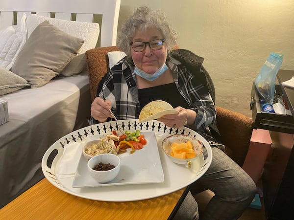 Susan Oliviero enjoys her first meal at home after being discharged from the hospital. (Helena Oliviero / helena.oliviero@ajc.com) 