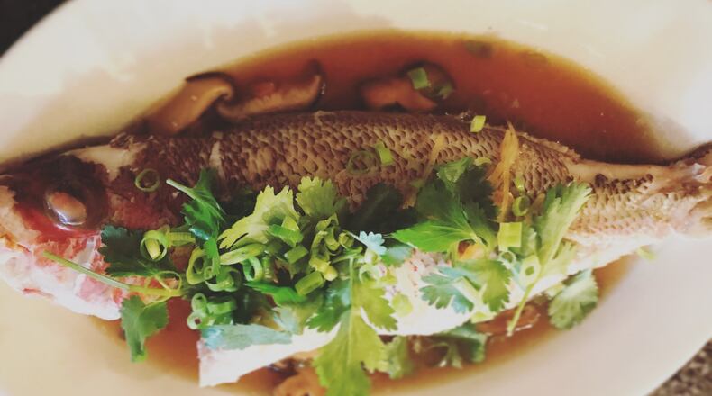 Talat Market’s “pla neung see ew” is a whole black sea bass with a broth of soy sauce, ginger, scallions, garlic and shiitakes. CONTRIBUTED BY BRANDI SUPRATANAPONGSE