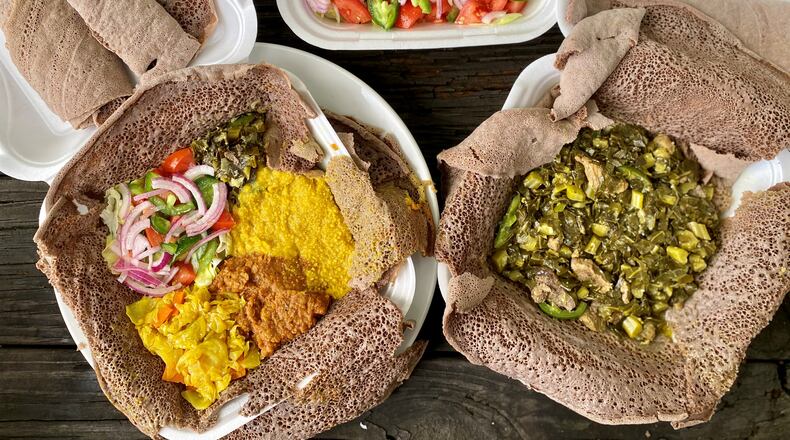 This takeout feast from Chef Winnie’s Kitchen in Clarkston includes injera, fish curry, gomen be sega (collards with meat) and the vegan sampler.
Wendell Brock for The Atlanta Journal Constitution
