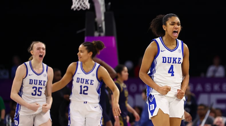 Duke forwards Toby Fournier (35), and Delaney Thomas (12), and guard Riley Nelson (4) react after an NCAA college basketball game in the semifinals of the Atlantic Coast Conference tournament against Notre Dame, Saturday, March 7, 2026, in Duluth, Ga. (AP Photo/Colin Hubbard)