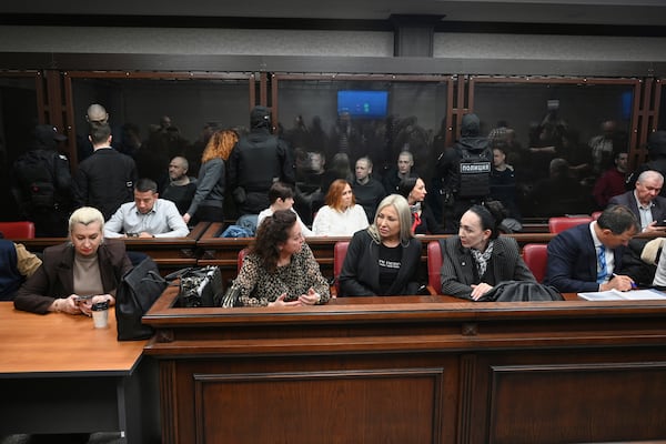 Lawyers of Ukrainians captured by Russia during hostilities in Ukraine sit in front of the defendant's cage during a hearing at the Southern District Military Court in Rostov-on-Don, Russia, Wednesday, March 26, 2025. (AP Photo)