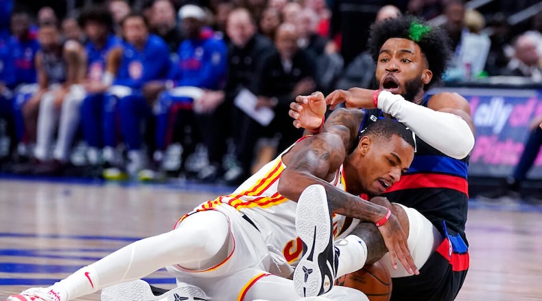 Atlanta Hawks guard Dejounte Murray (5) and Detroit Pistons forward Saddiq Bey (41) get tangled up during the first half of an NBA basketball game, Wednesday, Oct. 26, 2022, in Detroit. (AP Photo/Carlos Osorio)